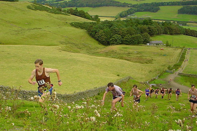 part of the cloud of brown vests (HBT) begin to climb Grieston Hill in pursuit of Colin Donnelly (out of shot)