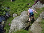 Susan Davis negotiates boulders beside the Carey Burn - photo: Rob